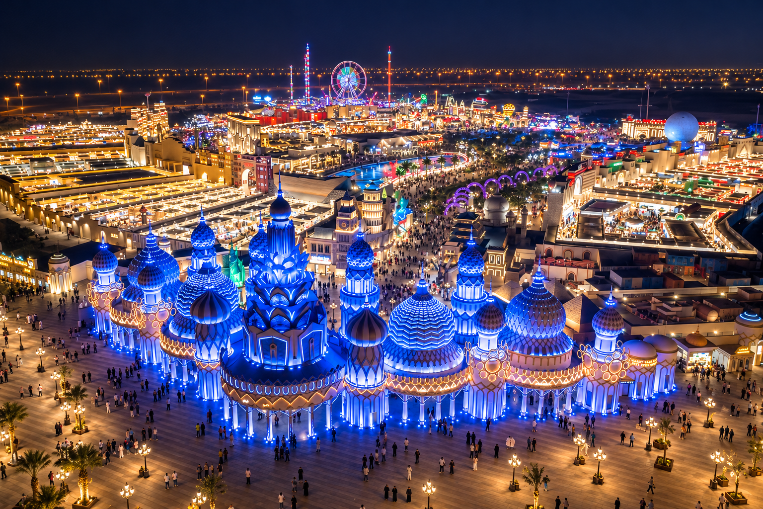 AI-enhanced aerial night view of Global Village in Dubai, based on supplied photographs, with blue-lit domes and the illuminated festival park